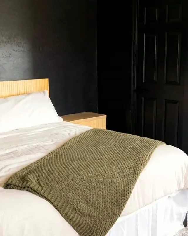 Inside a Premium Two Bedroom cabin: a king bed, and the companion door through to the second bedroom